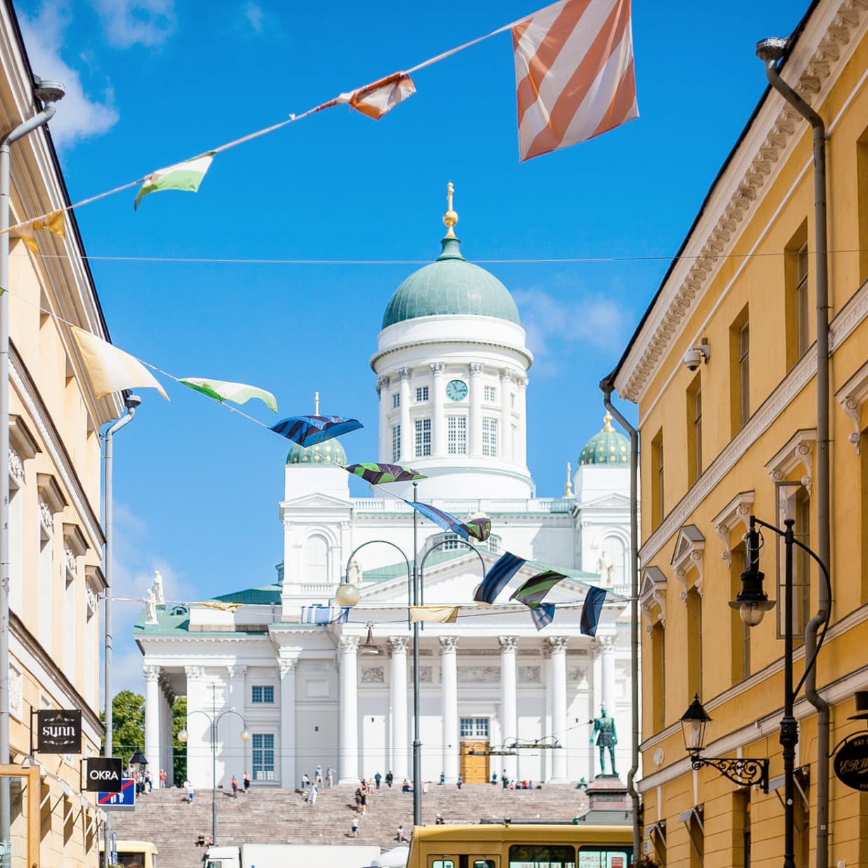 Helsinki Cathedral seen down a flag-lined street in the Torikorttelit quarter
